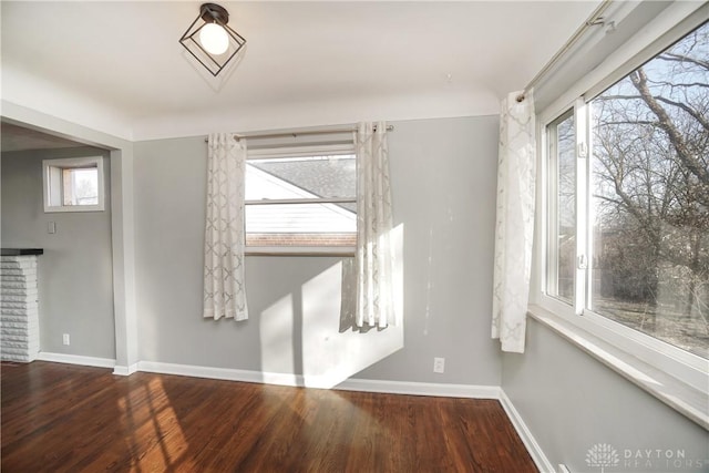 unfurnished room with a fireplace and wood-type flooring