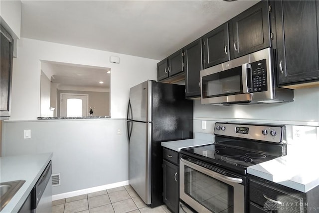 kitchen with light tile patterned flooring, appliances with stainless steel finishes, and sink