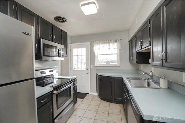 kitchen featuring appliances with stainless steel finishes, sink, and light tile patterned floors