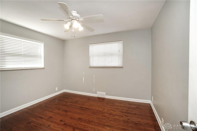 empty room featuring ceiling fan and dark hardwood / wood-style floors