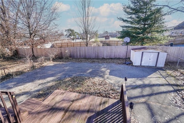 view of yard with a storage shed and a deck