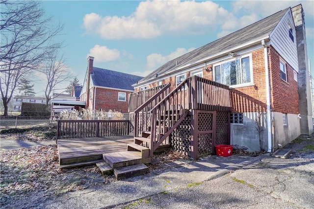 back of house with a deck