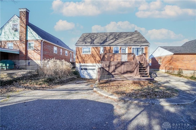 view of front facade featuring a garage and a deck