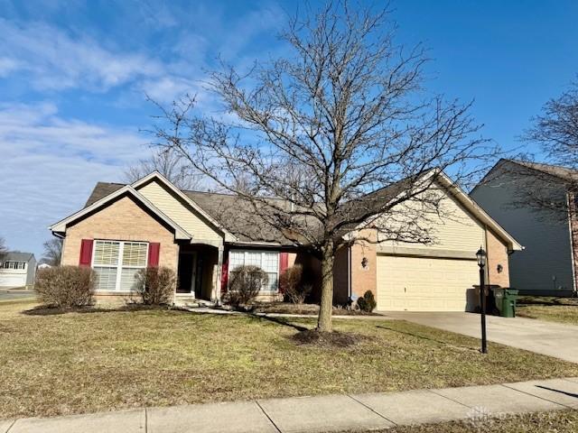 ranch-style home with a garage and a front yard