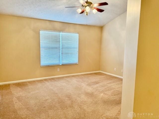 spare room featuring carpet, a textured ceiling, and ceiling fan