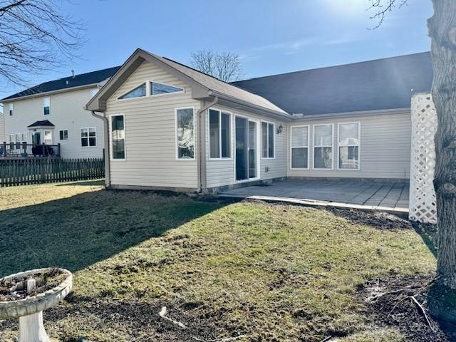 back of house featuring a yard and a patio area