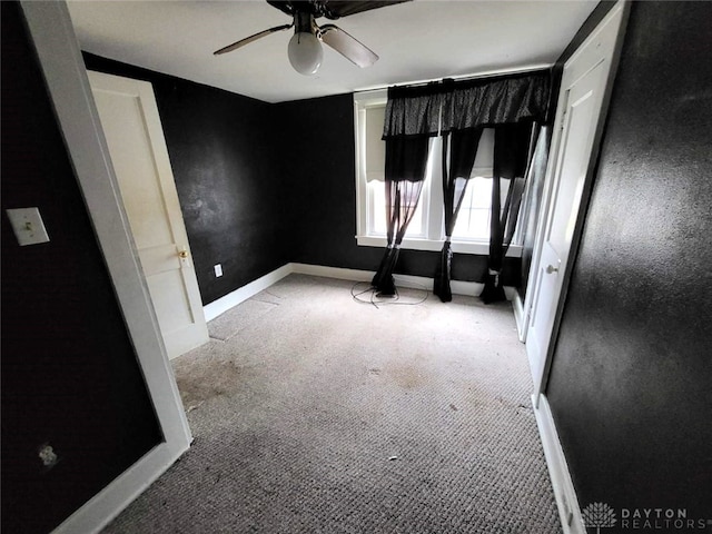 unfurnished room with light colored carpet and ceiling fan