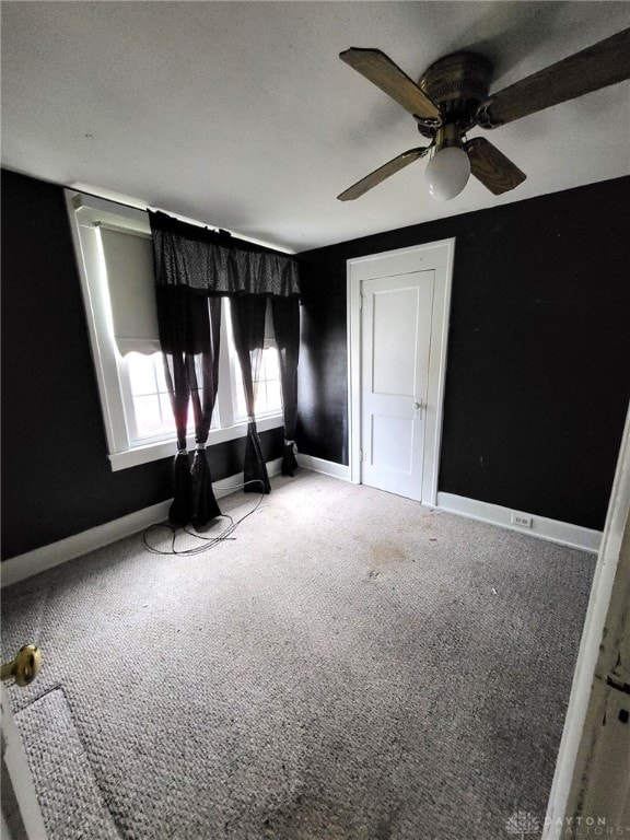 interior space featuring carpet floors and ceiling fan