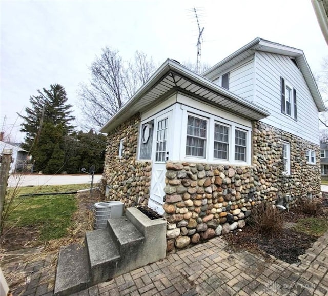 view of home's exterior with central AC unit