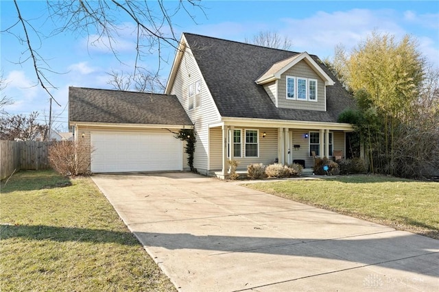 new england style home with fence, concrete driveway, a front yard, a shingled roof, and an attached garage