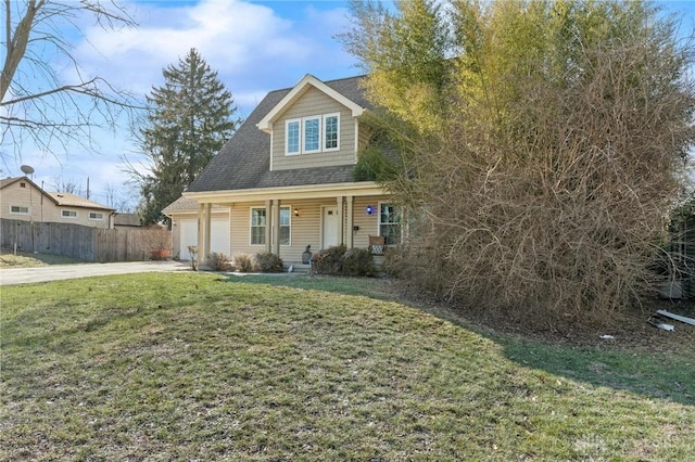 view of front of property with an attached garage, concrete driveway, a front yard, and fence