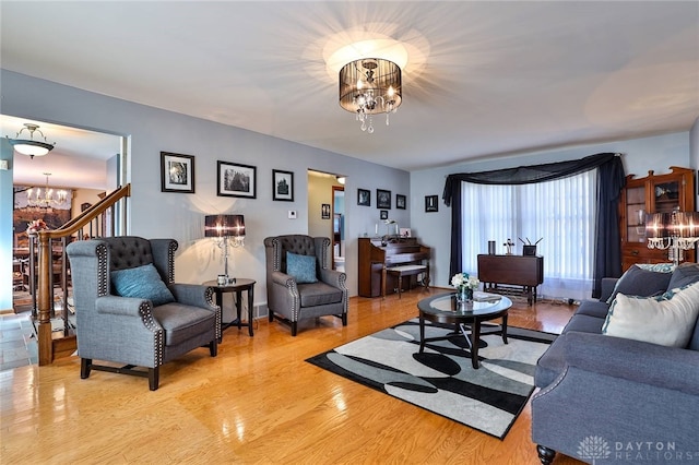 living room with an inviting chandelier and wood-type flooring