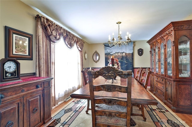 dining room with a chandelier and light wood-type flooring