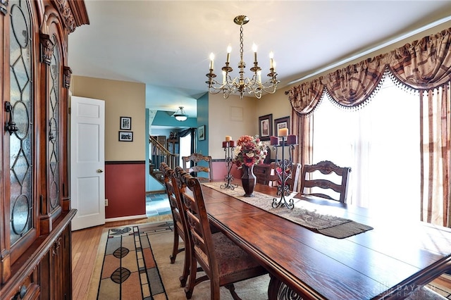 dining space featuring an inviting chandelier and light wood-type flooring