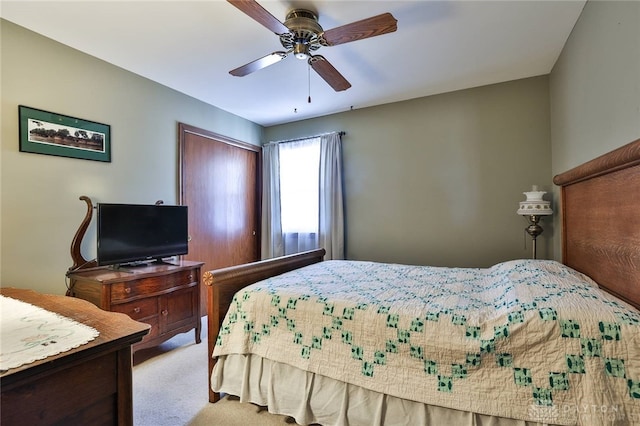 bedroom with light carpet and ceiling fan