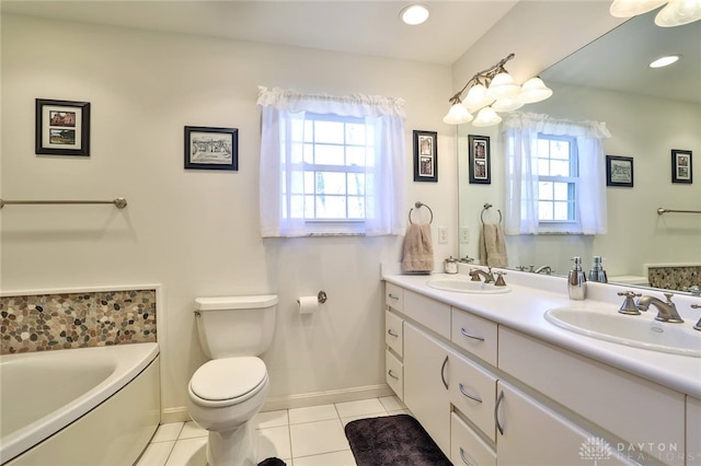 bathroom with vanity, a bath, tile patterned flooring, and a wealth of natural light