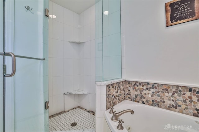 bathroom featuring shower with separate bathtub