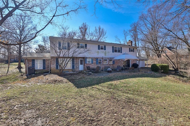 rear view of property featuring a gazebo, central AC, and a lawn