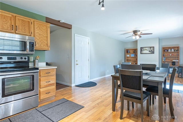 dining area featuring ceiling fan and light hardwood / wood-style flooring