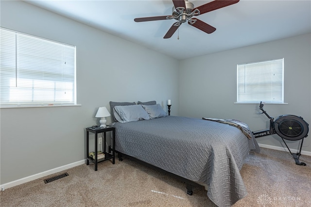 bedroom with light carpet and ceiling fan