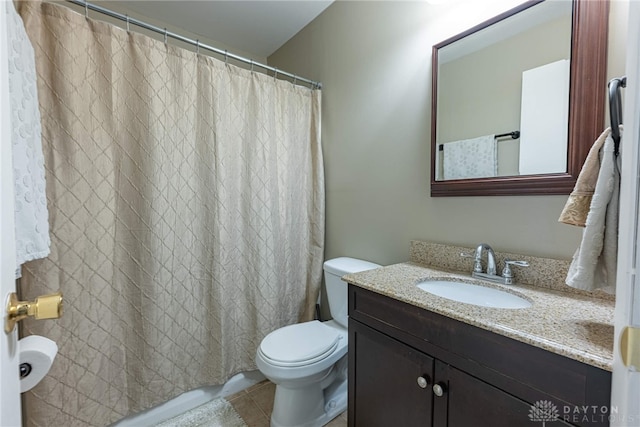 bathroom featuring vanity, toilet, and tile patterned flooring