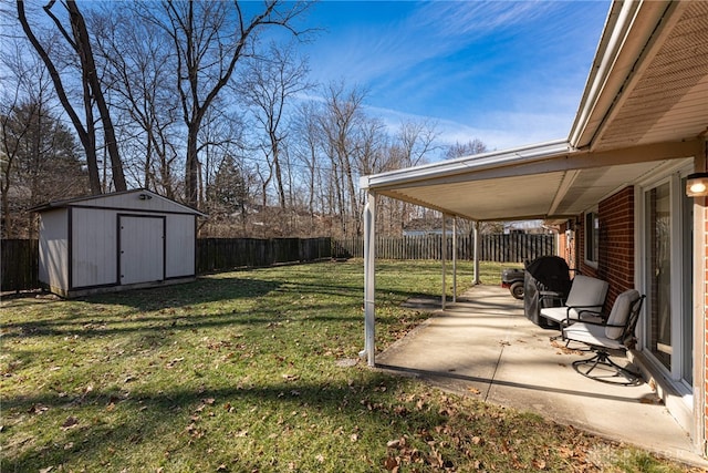 view of yard with a patio area and a storage shed