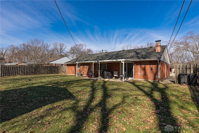 back of property featuring a yard and a patio