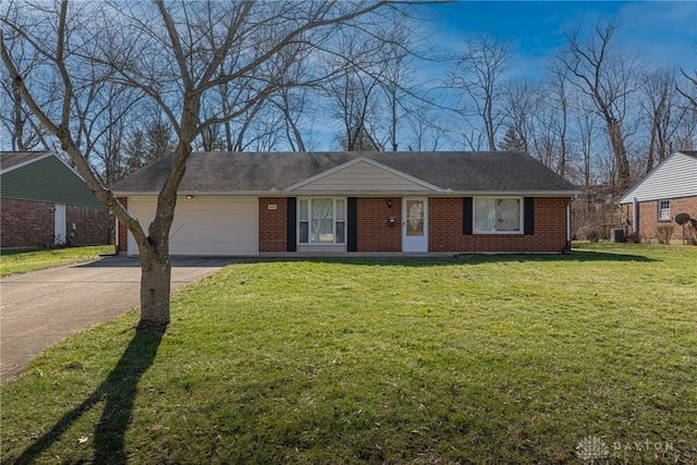 ranch-style home with a garage and a front lawn