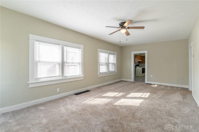 unfurnished bedroom with light colored carpet and ceiling fan