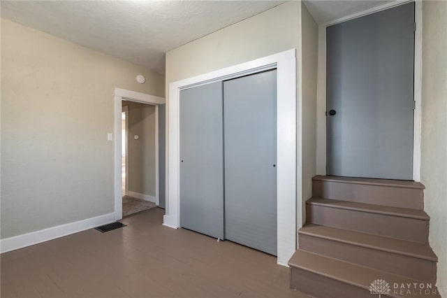 unfurnished bedroom with hardwood / wood-style flooring and a closet