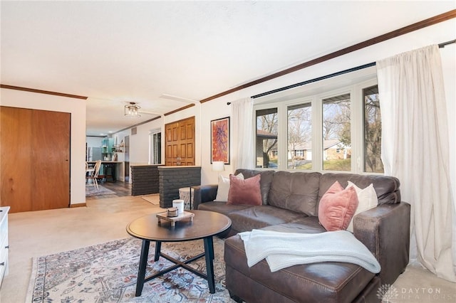 living room featuring ornamental molding and light colored carpet