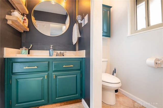 bathroom featuring tile patterned flooring, vanity, and toilet