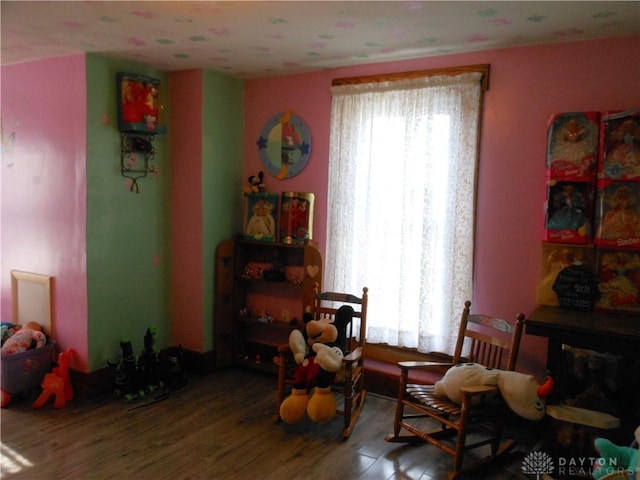 sitting room with hardwood / wood-style flooring and a healthy amount of sunlight