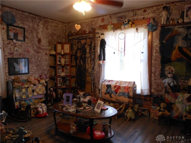 sitting room with hardwood / wood-style flooring and ceiling fan