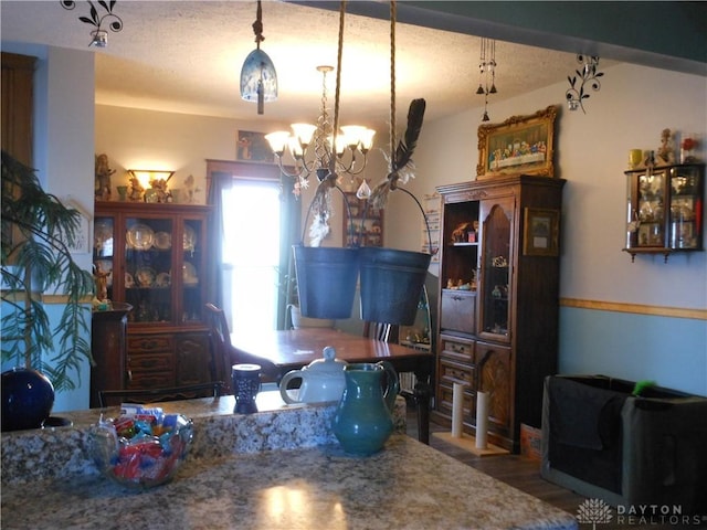 dining room with an inviting chandelier and hardwood / wood-style flooring