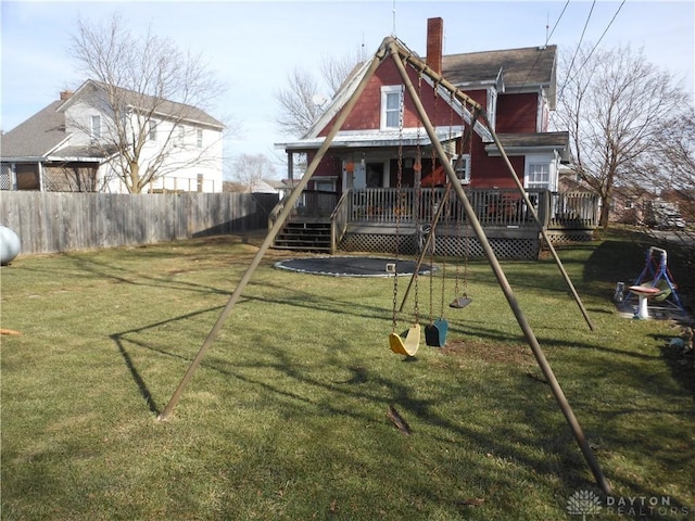 view of play area with a deck and a lawn