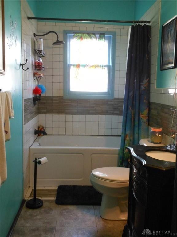 full bathroom featuring vanity, tile patterned floors, toilet, and shower / bath combo