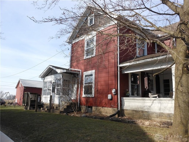 view of side of home featuring a yard