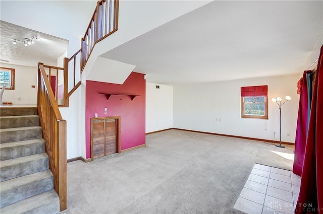 interior space featuring carpet flooring and baseboards