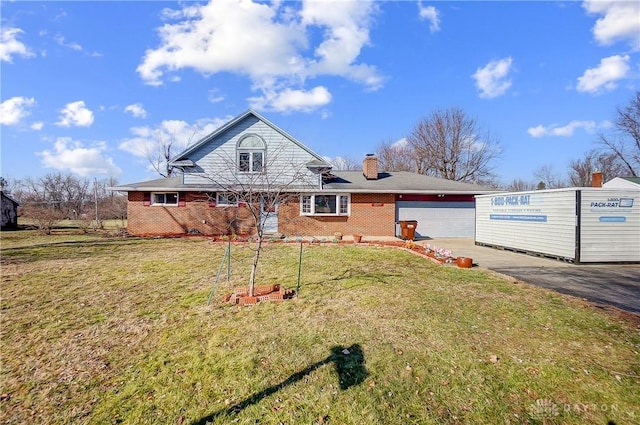 view of front of home featuring concrete driveway, a chimney, an attached garage, a front lawn, and brick siding