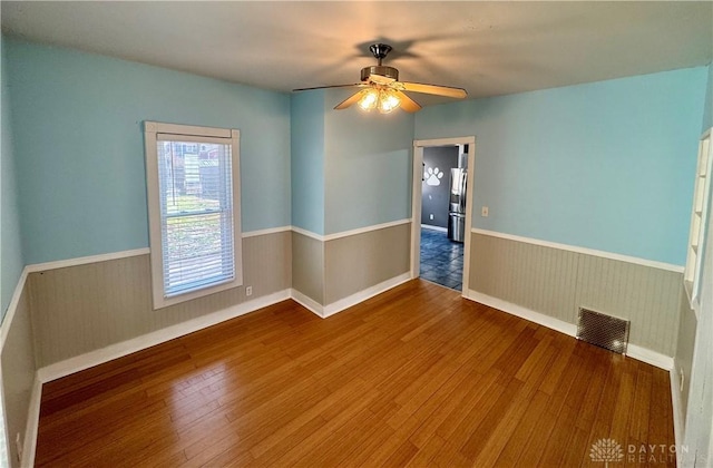 empty room featuring ceiling fan and wood-type flooring