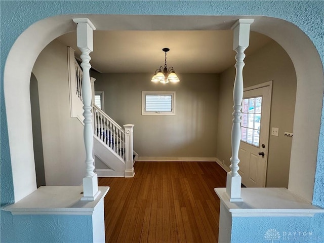 foyer featuring wood-type flooring and a chandelier