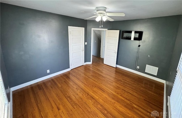 unfurnished bedroom with hardwood / wood-style flooring and ceiling fan