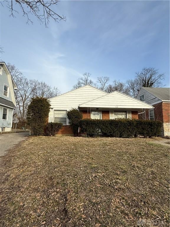 view of side of home with a yard