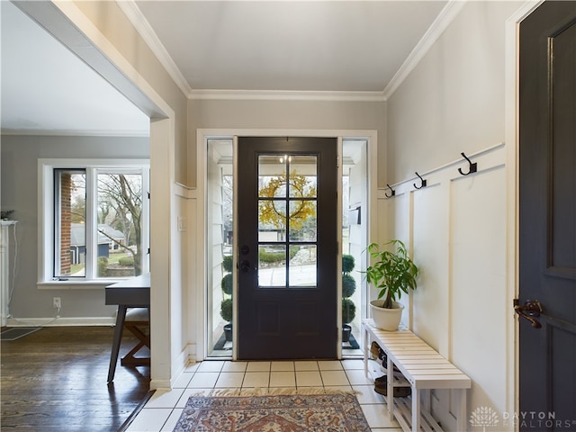 tiled foyer entrance with ornamental molding