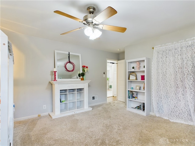 interior space featuring light carpet and ceiling fan