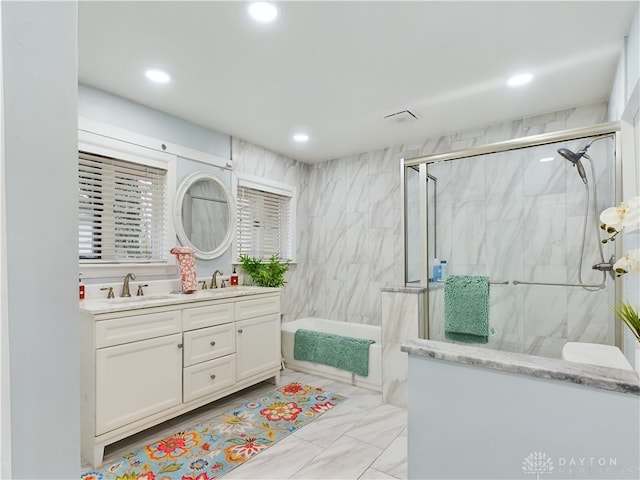 bathroom featuring vanity and tile walls