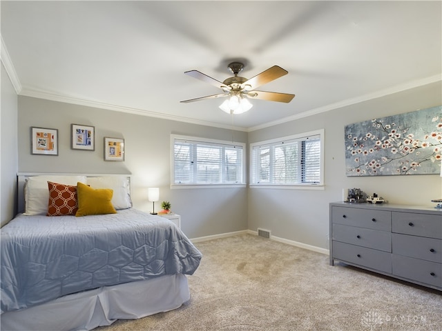 bedroom featuring crown molding, light colored carpet, and ceiling fan