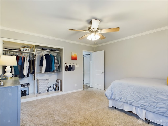 carpeted bedroom featuring crown molding, ceiling fan, and a closet