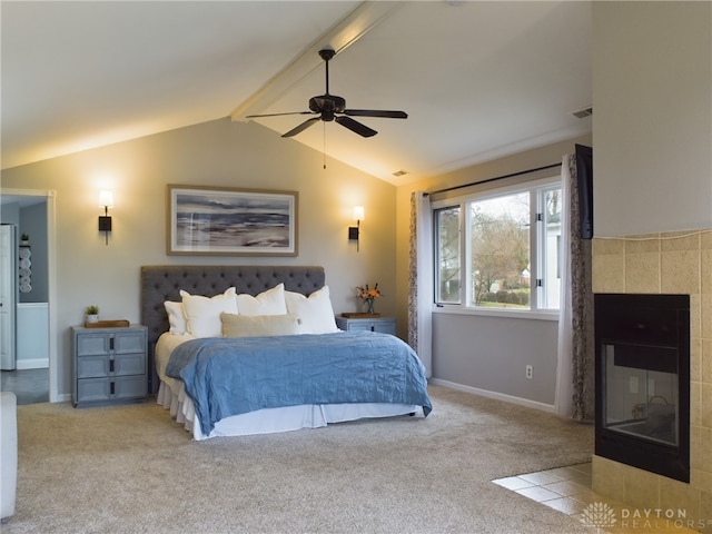 carpeted bedroom featuring ceiling fan, a fireplace, and lofted ceiling with beams